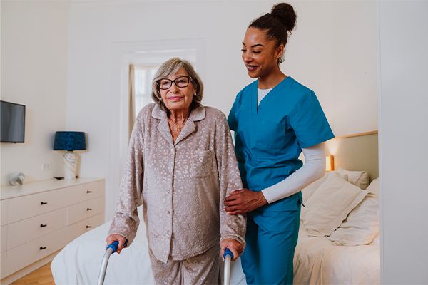 Friendly caregiver providing in-home assistance to senior client