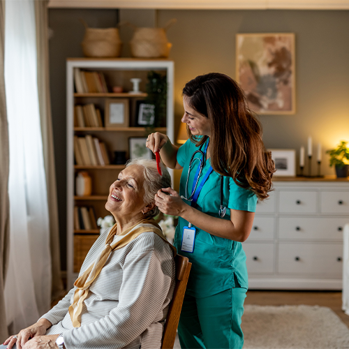Woman home care aide combing senior client hair in Atlanta, Ga