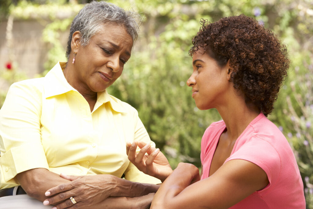 Adult daughter comforting senior mom about receiving home care services.